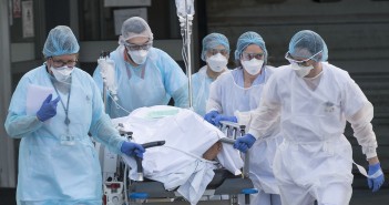 Medical staff push a patient on a gurney to a waiting medical helicopter at the Emile Muller hospital in Mulhouse, eastern France, to be evacuated on another hospital on March 17, 2020, amid the outbreak of the new Coronavirus, COVID-19. - A strict lock down requiring most people in France to remain at home came into effect at midday on March 17, 2020, prohibiting all but essential outings in a bid to curb the coronavirus spread. The country has reported 148 deaths from the virus, a number that health experts warn could soar in the coming days, seriously straining the hospital system. (Photo by SEBASTIEN BOZON / AFP)