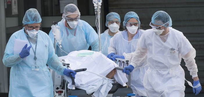 Medical staff push a patient on a gurney to a waiting medical helicopter at the Emile Muller hospital in Mulhouse, eastern France, to be evacuated on another hospital on March 17, 2020, amid the outbreak of the new Coronavirus, COVID-19. - A strict lock down requiring most people in France to remain at home came into effect at midday on March 17, 2020, prohibiting all but essential outings in a bid to curb the coronavirus spread. The country has reported 148 deaths from the virus, a number that health experts warn could soar in the coming days, seriously straining the hospital system. (Photo by SEBASTIEN BOZON / AFP)